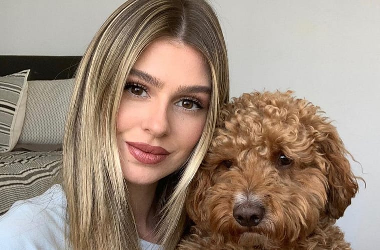 Raquel Leviss taking a (horizontal) selfie with her Goldendoodle dog Graham Cracker