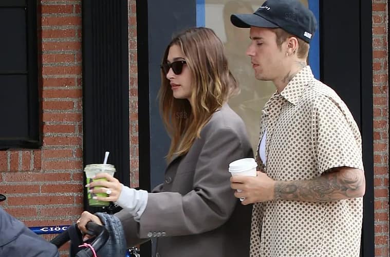 Hailey and Justin Bieber pushing a stroller. Fans wait to see Jack Blues Bieber