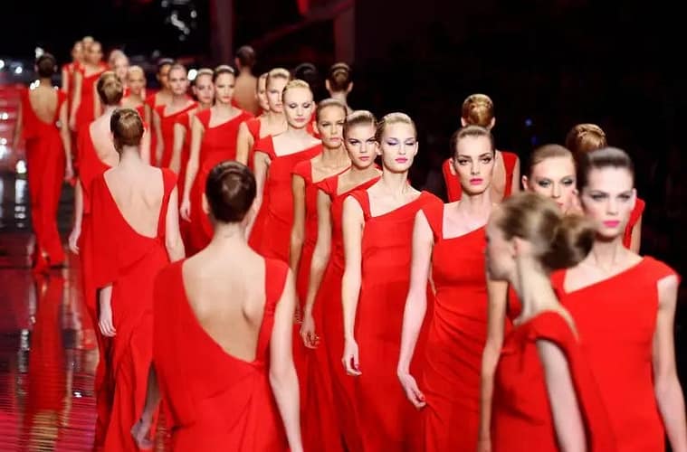 Valentino Fashion Show of models in red dresses