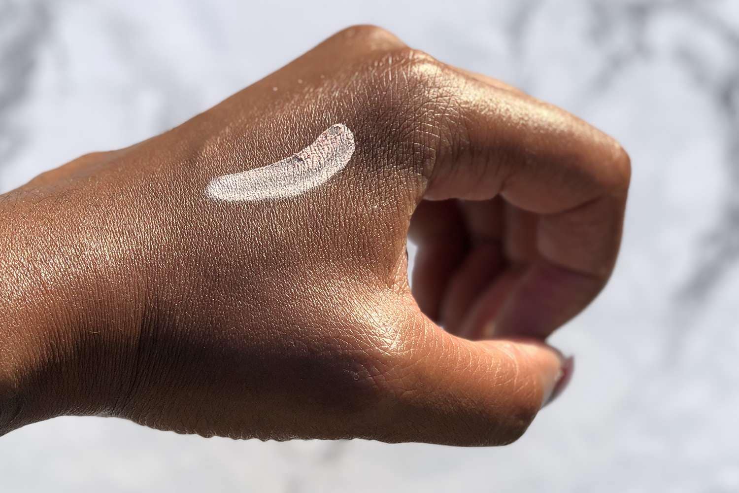 Someone showing what the drying lotion looks like.