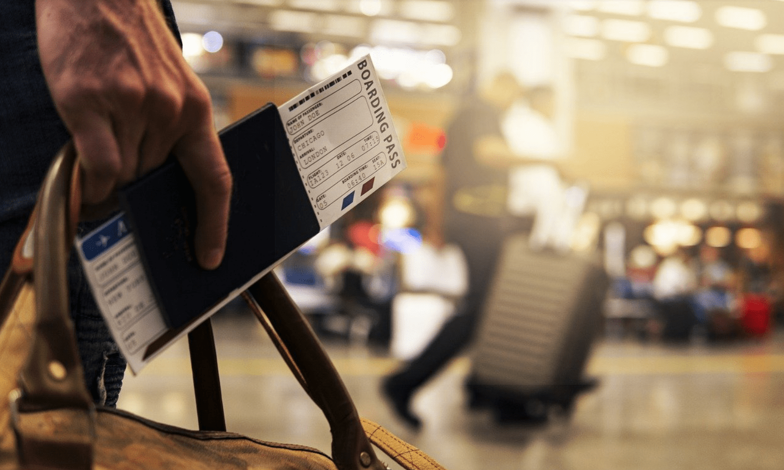 person holding passport and walking through airport