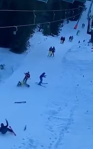 Snowboarder wipes out slope of people