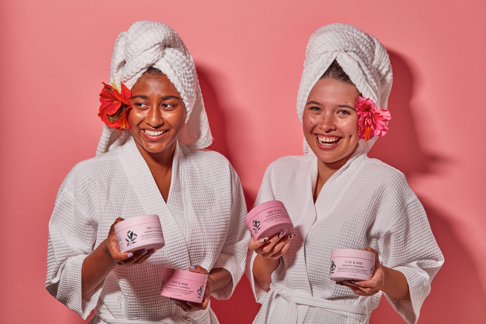 women holding cleanser and conditioner set