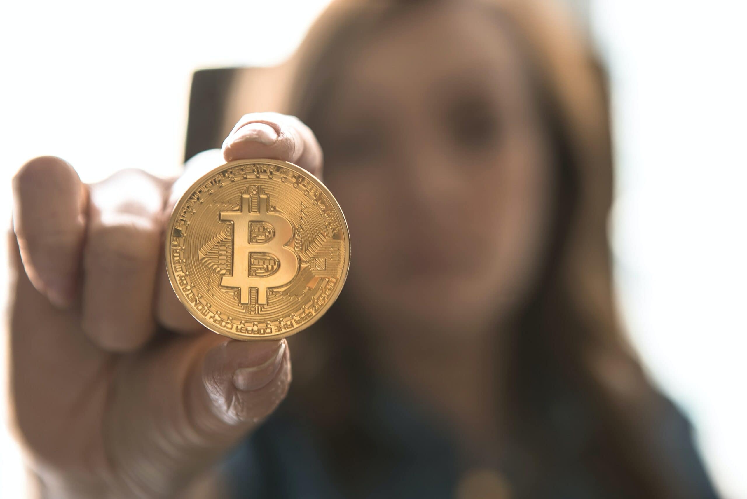 Woman holding a bitcoin