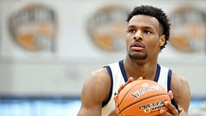 Bronny James warms up at halftime during a high school basketball game