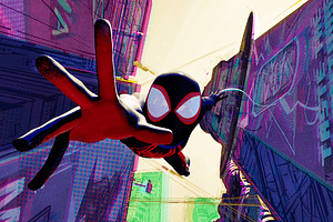 Miles Morales as SpiderMan falling in-between buildings reaching out to the screen
