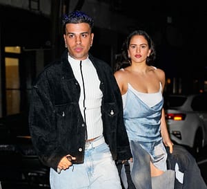 A paparazzi Rosalia (right) and Rauw Alejandro (left) holding hands.