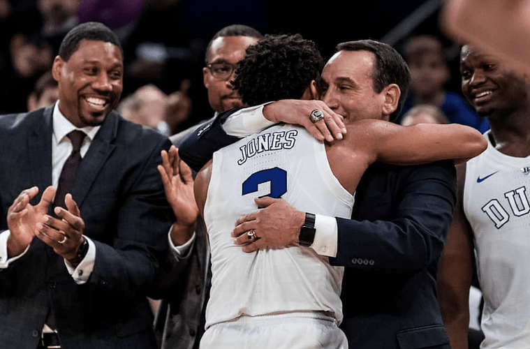 Coach K hugging basketball player