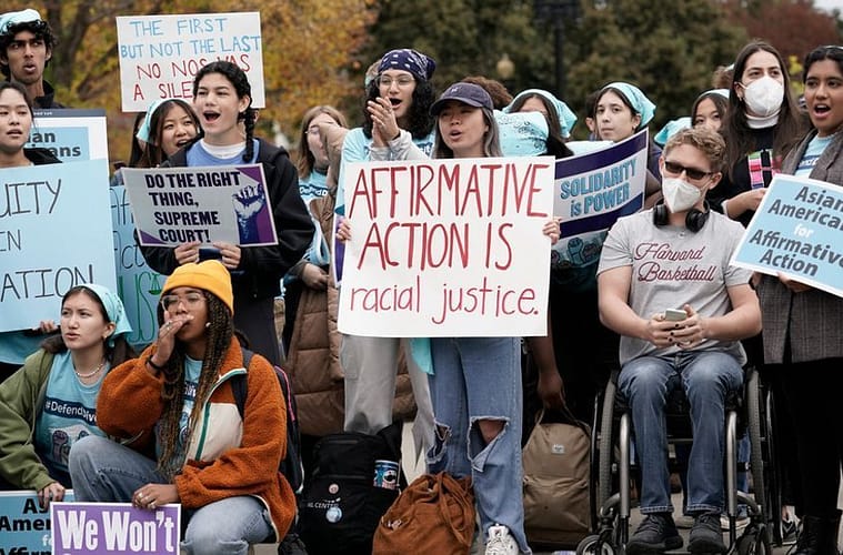 People rally outside the Supreme Court as the court begins to hear oral arguments in two cases that could decide the future of affirmative action in college admissions