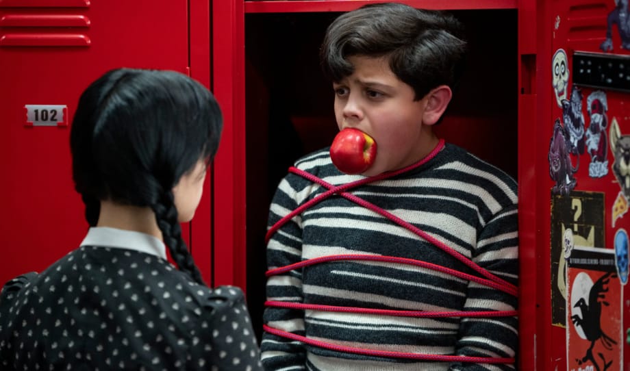 Wednesday pushing classmate into locker, "Wednesday" on Neflix