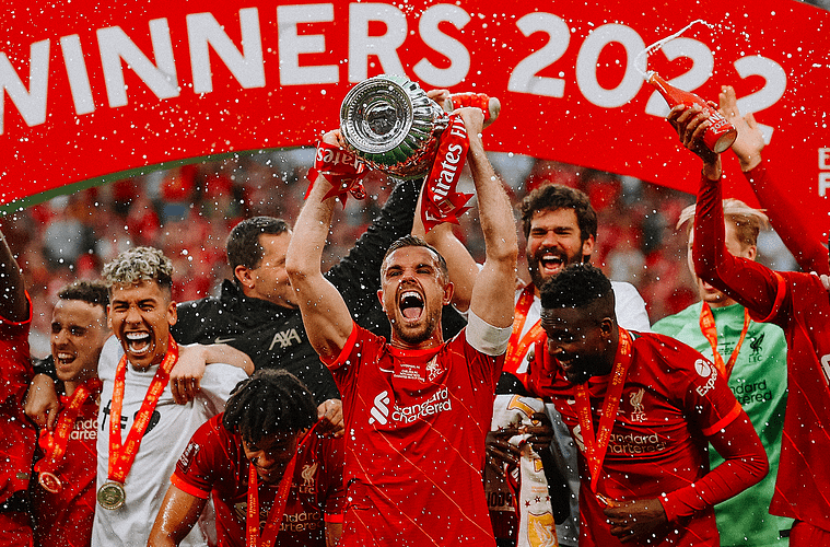 Liverpool captain Jordan Henderson lifts the trophy with his team.
