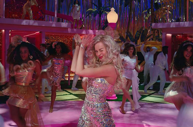 Margot Robbie clapping and winking as 'stereotypical Barbie' at her dream house dance party